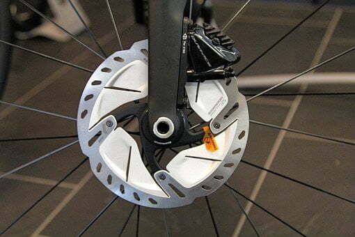 close up of two piece disc brake and caliper on bicycle wheel